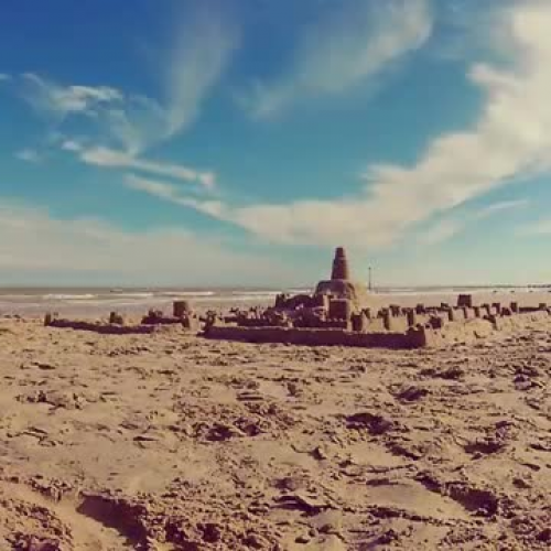 Sea Washes away Sandcastle